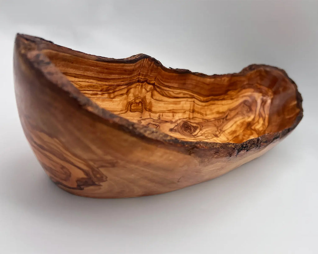 Hand-carved rustic olive wood bread and fruit bowl with unique natural grain patterns. Perfect for serving bread, fruits, or as a decorative piece.